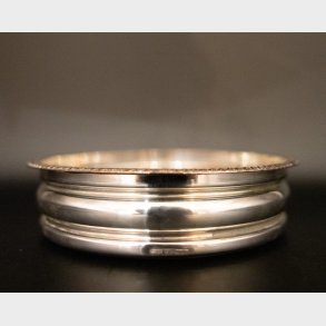 Vintage silver-plated wine bottle coaster with wooden base