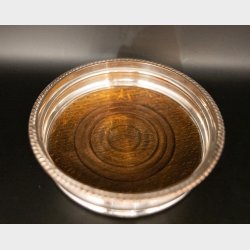 Vintage silver-plated wine bottle coaster with wooden base